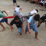 Group of Boys Playing a Game of Pulling Each Other